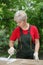 Female worker restoring old wooden door