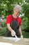 Female worker restoring old wooden door