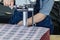 Female worker on a sewing manufacture uses electric cutting fabric machine. Textile industry, clothing production, fabric cutting