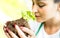 Female worker taking care on newborn basil plant at biological farm - Organic agronomy and earth day concept with farmer