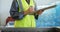 Female worker writing on clipboard in olive factory 4k