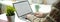 A female working on blank screen laptop with coffee mug and decoration on simple worktable