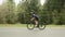 Female working out on bike. Woman riding on bicycle. Athlete sprinting out of saddle on road bicycle, taking part in competition.