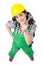 Female workman in green overalls holding key