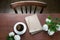 Female workplace blogger with cup of black coffee, note on wooden table. Top view. Coffee break. Work it home. Life Style. Start o