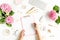 Female workspace with female hands, clipboard, bouquet hydrangea, computer, accessories on white background. Stylized