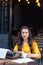 Female writer with vintage typewriter in a coffee shop