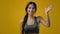 Female in yellow studio background friendly smiling Indian sports woman sporty lady athlete girl in sportswear smiling