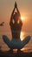 Female yoga practitioner gracefully holds tree pose at beach during stunning sunset