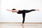 Female yogi standing on one leg. Yoga asana Warrior 3 Pose. Balance between body and spiritual essence. White background