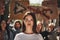 Female young activist with word freedom written on her face protesting outdoors with group of demonstrators. Ecology