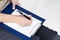 Females in Business Closeup of Hands of Caucasain Woman Writing on Paper Sheet on Notepad