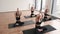 Females doing Padmasana with hands above head in yoga class