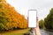 A females hand holds a smartphone in her hand, close-up. Autumn Park in the background in the blur. Concept of modern technologies