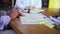 A females hands writing notes in notepad. Writing down business ideas. Closeup of two business woman hand write notes