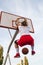 Females playing basketball on street court. Woman streetball player making slam dunk in a basketball game.