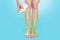 Females smooth legs, with the smell coming from them, which are sprayed with medicine. Blue background. Copy space. The concept o