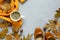 Feminine autumn accessories. Scarf and shoes, cup of coffee, oak leaves and acorns on gray wooden background. Flat lay.