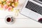 Feminine business mockup with laptop, roses bouquet and cup of c