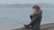 Feminine girl standing on the seafront promenade