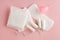 Feminine hygiene and protection products, sanitary pads, tampons and menstrual cup on pastel pink background, top view, flat layou