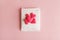 feminine hygiene and protection, sanitary pad with heap of red hearts on pastel pink background, top view, flat layout