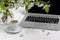 Feminine workplace concept. Freelance fashion comfortable femininity workspace  with laptop, coffee, flowers on white background