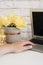 Feminine workplace concept. Freelance workspace with laptop, flowers, golden pineapple, woman hand. Blogger working. Bright, yello