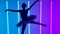 Feminine young graceful ballerina dancing elements of classical ballet in a dark studio against a background of blue and