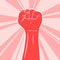 Feminism logo symbol. Illustration of monotone hand with white outline on bright pink rays in background. Raised feminist fist