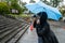 A femla tourist in Nikko making photos in the rain