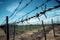 Fence with barbed metal wire separates countries border outdoor