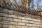 Fence of brick and wrought iron fence. Image of a decorative cast iron fence. metal fence close up.