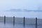 The fence of the city embankment during flooding with water and fog. Blagoveshchensk, Russia.