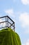 Fence on a cliff steep with cloud in blue sky