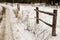 Fence on a frosted road in a forest