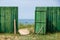 Fence gate in the green board fence on the beach of Baltic sea
