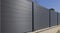 Fence of gray aluminum slats on a house