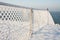 Fence with hoarfrost in the winter