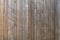 Fence of old unpainted boards background closeup
