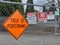 Fence outside a construction site warning pedestrians and trespassers of traffic