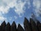 Fence palisade against the blue sky