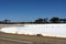 Fence posts through salt lake between Hyden and Albany, WA, Australia