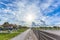 Fence, road and rising sun, HDR