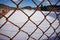 Fence with rust in front of snow