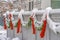 Fence with snowy garland and red bows in Daybreak