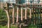 On  fence stands a self-carved wind chime made of wood