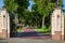 The fence with stone pedestals and iron wrought iron gates.