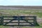 Fence to a nature reserve,Noard-Fryslan Butendyks, Friesland, Holwerd, The Netherlands. A sign with the Dutch text