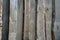 Fence from unpainted boards. Solid opaque wall. Wood texture and fibers.